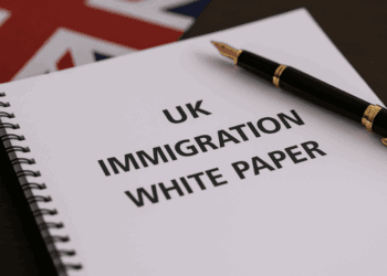 UK Immigration White Paper document with pen and Union Jack – BIC Immigration policy and visa services