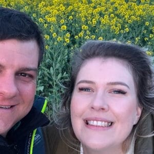 Smiling couple outdoors representing a successful immigration client testimonial