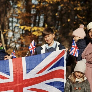 Family holding a United Kingdom flag to represent successful British citizenship outcome