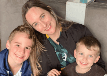 Smiling parent with children representing a positive family immigration testimonial
