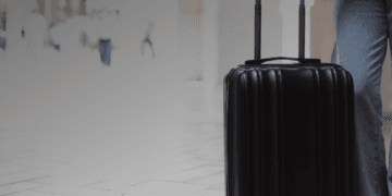 Traveller standing with a suitcase before departing for international travel from South Africa